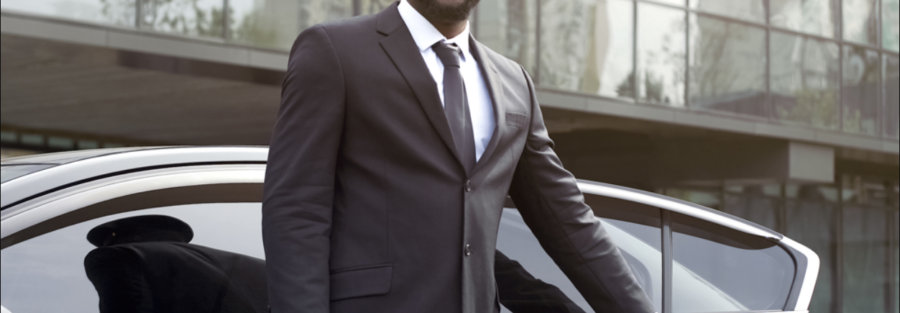 Professional chauffeur opening a luxury limo door