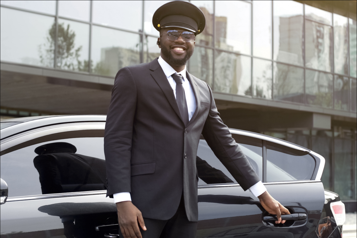 Professional chauffeur opening a luxury limo door